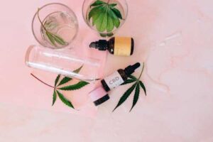CBD tincture bottles with cannabis leaves - natural hemp wellness products
