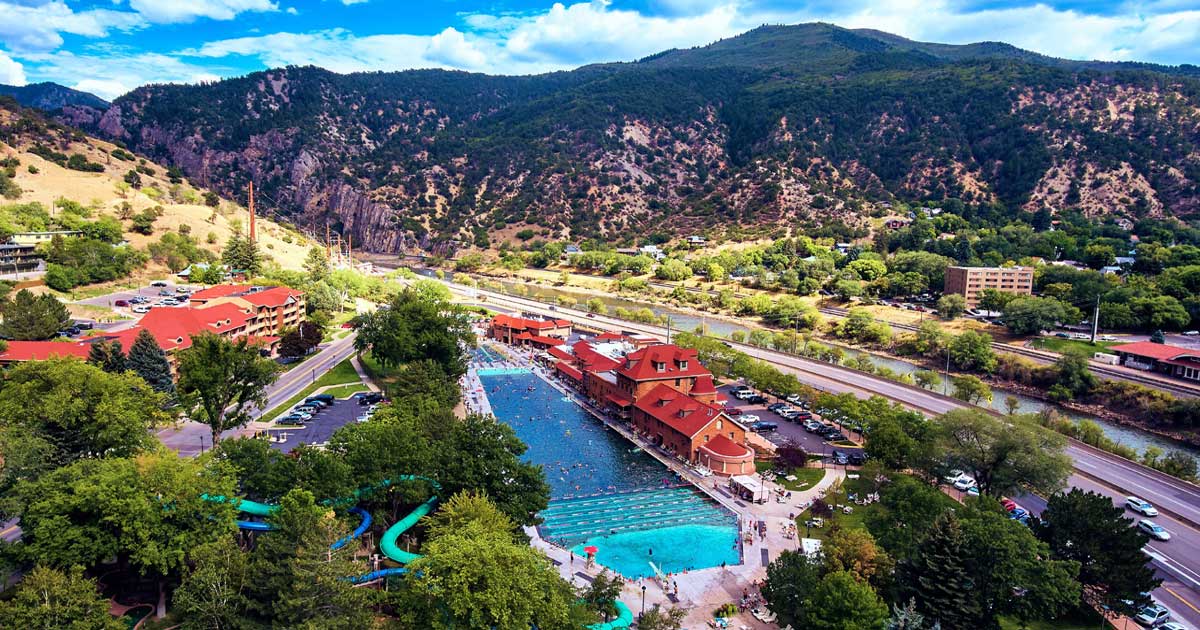 Glenwood Hot Springs pool with the Rocky Mountains in the background - or an aerial shot of the massive pool complex with mountain scenery.