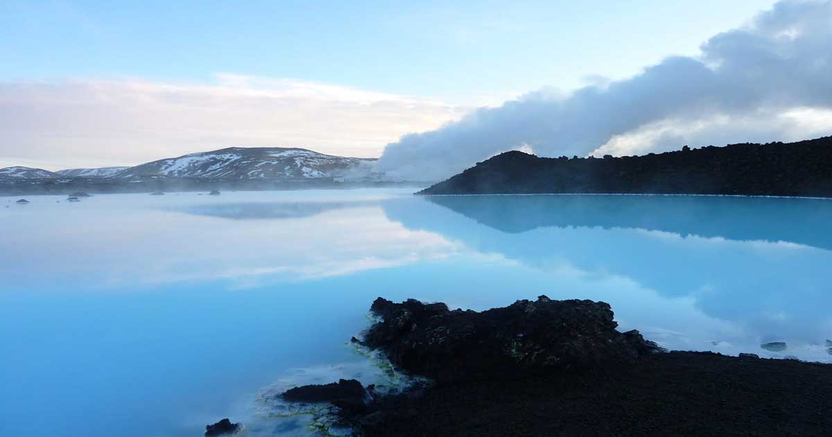 Reykjavik, Iceland Blue Lagoon milky blue water against volcanic black rock landscape