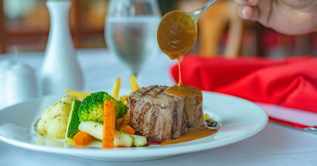 Perfectly plated steak with roasted vegetables and sauce - fine dining at home