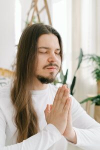 person in peaceful meditation - soft natural light, serene setting, eyes closed