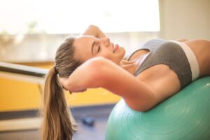 Woman doing core exercise on a stability ball for strength and balance training